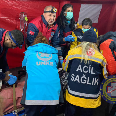 Removing him from the stretcher for medical checks